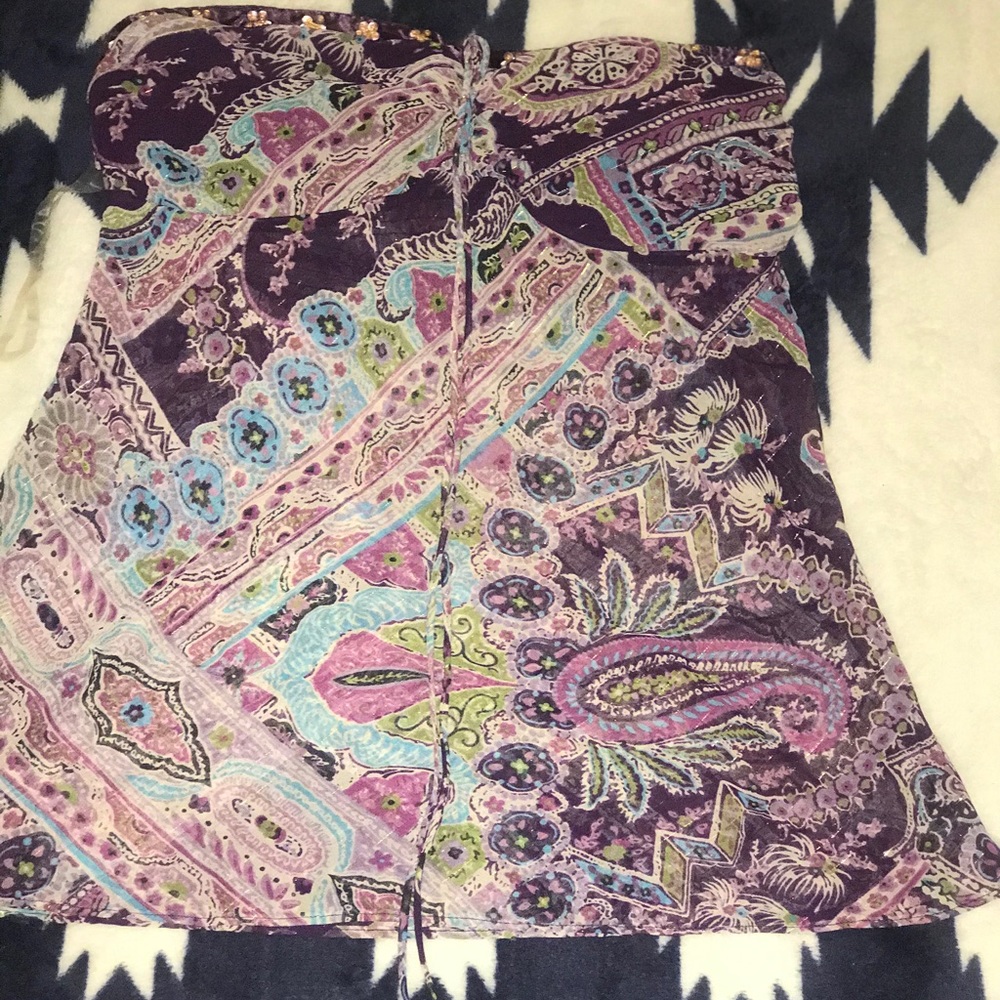 A purple, blue and green off the shoulder shirt.